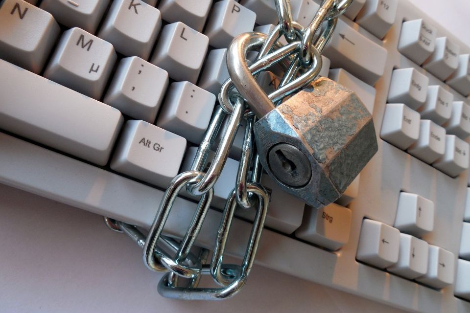 Image shows a keyboard which is locked by a chain and padlock.