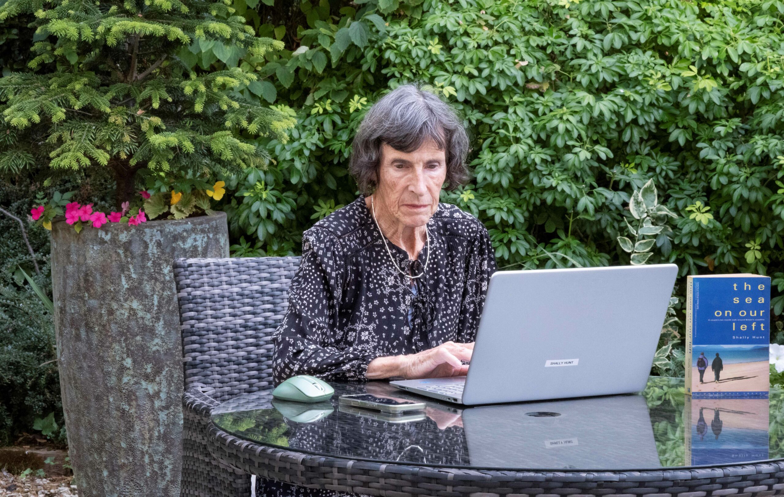 Shows Shally Hunt, an author living in a care home, using her laptop to continue writing her autobiography.